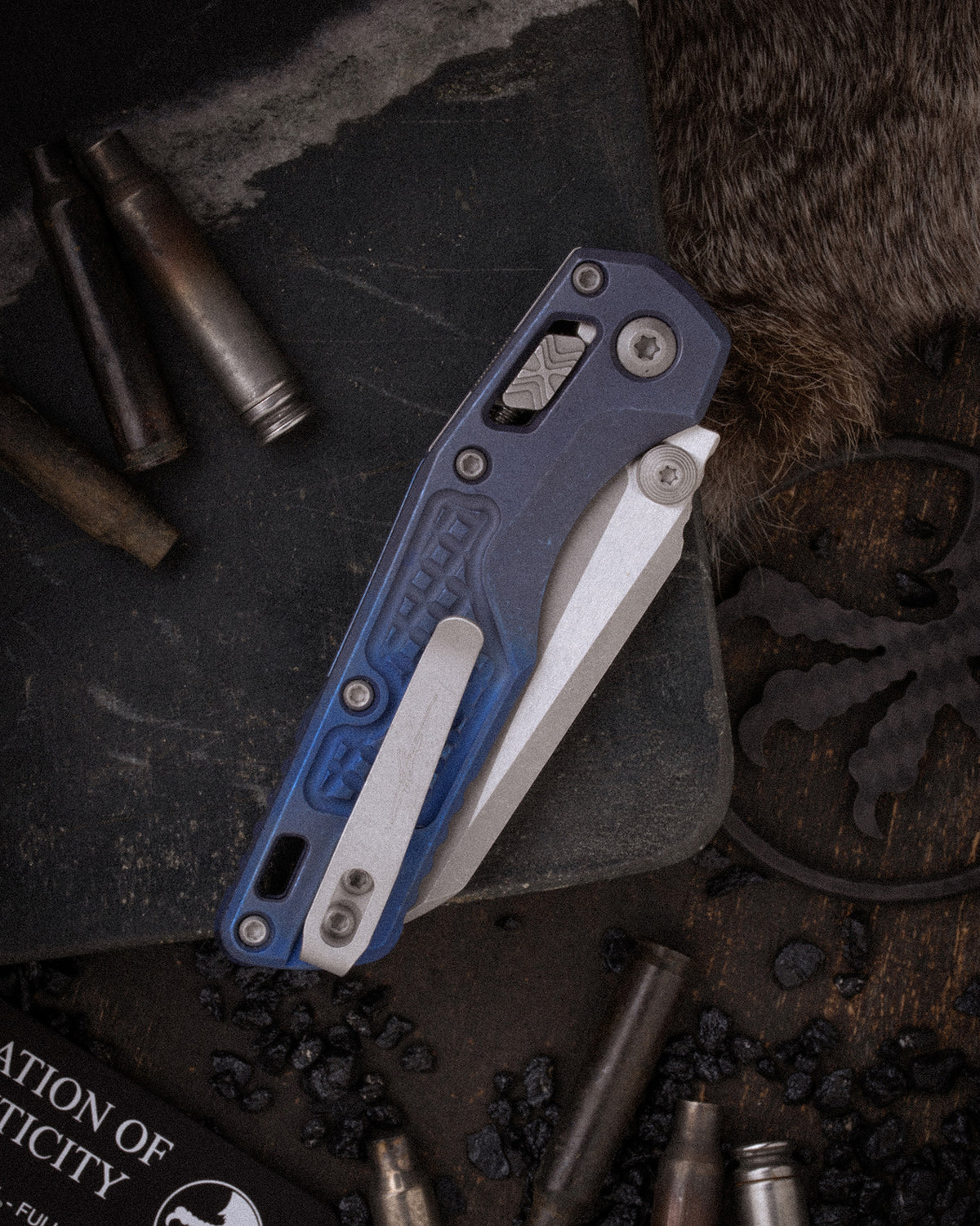 MSI® RAM-LOK® MINI FULL SERRATED MARFIONE SELECT APOCALYPTIC® FINISH ANTIQUE BLUE ANODIZED FRAG PATTERN TITANIUM W/ BLUE TITANIUM ACCENT APOCALYPTIC® STAINLESS (210M-12APFRMS2)