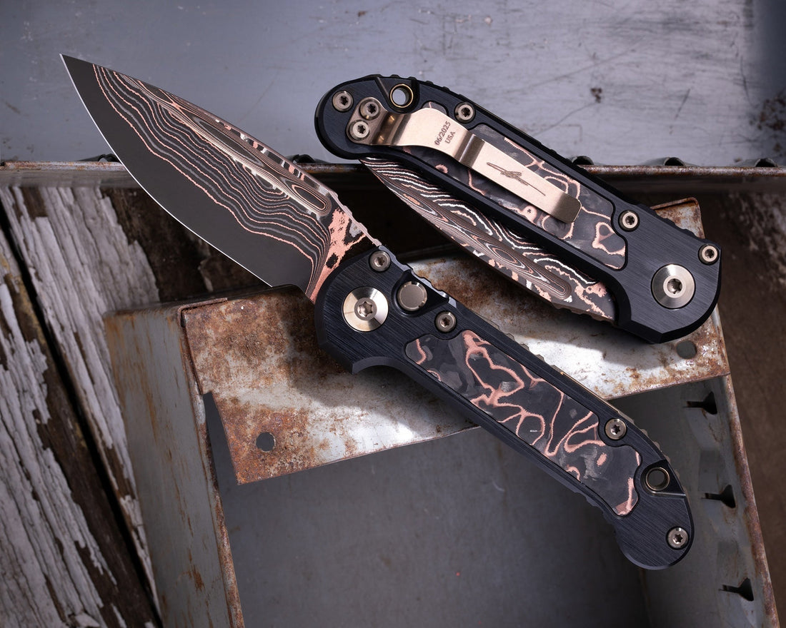 Custom LUDT folding knives with patterned blades and handles on rusty metal surface
