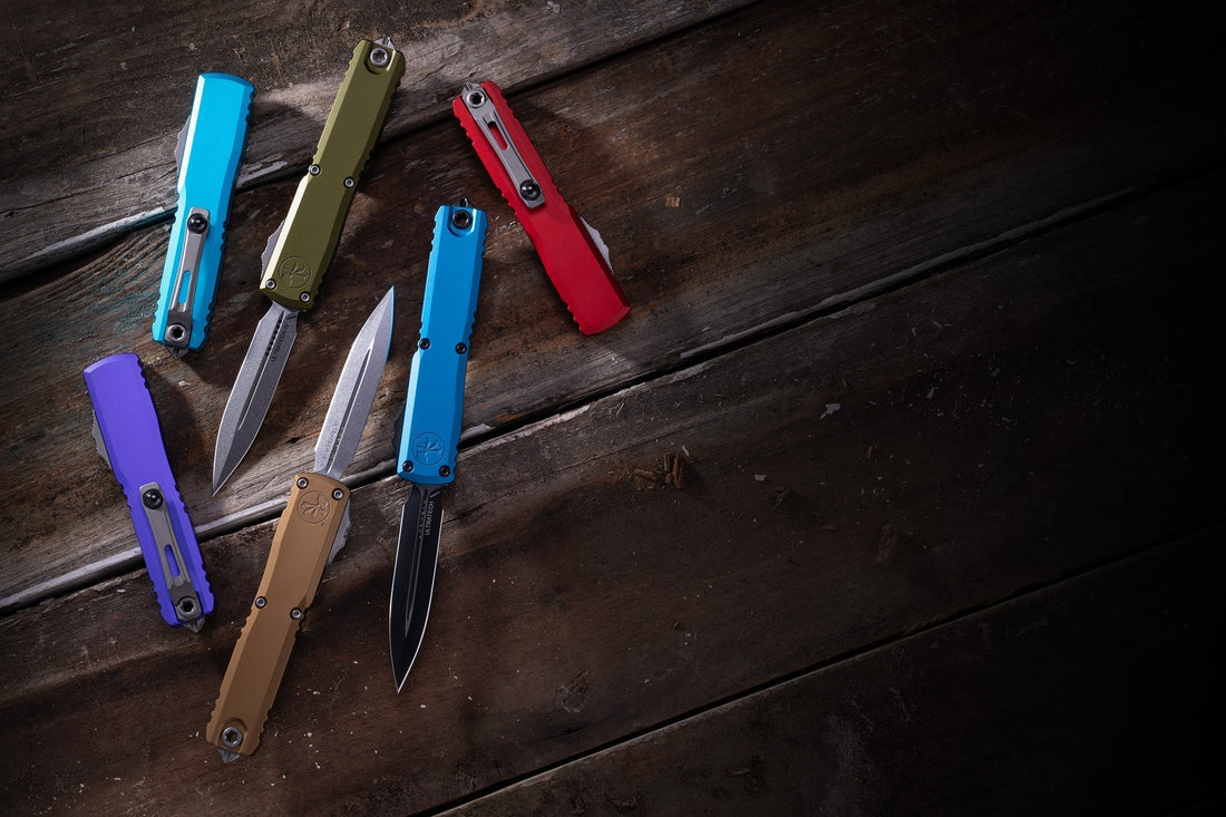 Colorful Ultratech Gen 4 folding knives on rustic wooden surface