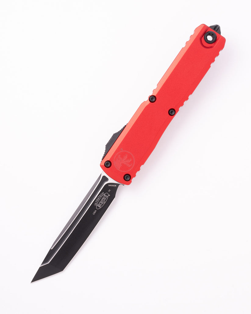 Microtech Ultratech OTF knife with multiple blade configurations displayed on dark tactical surface