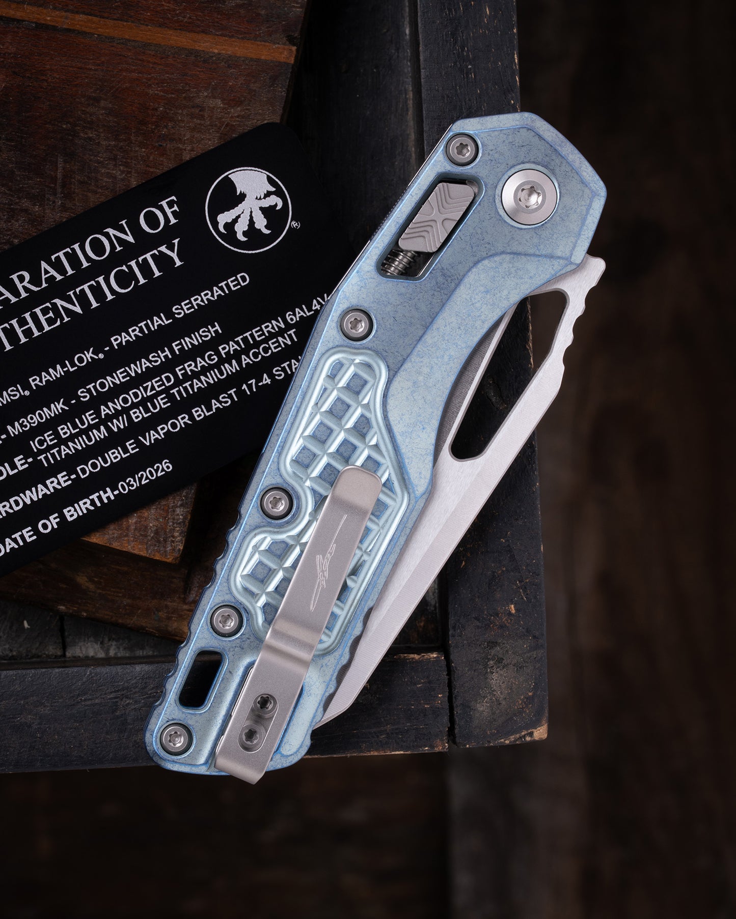 MSI® RAM-LOK® MARFIONE SELECT PARTIAL SERRATED STONEWASH FINISH ICE BLUE ANODIZED FRAG PATTERN TITANIUM W/ BLUE TITANIUM ACCENT DOUBLE VAPOR BLAST STAINLESS (210-11FRMS6)