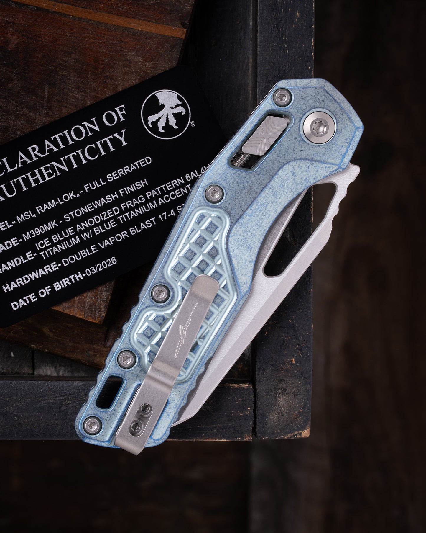 MSI® RAM-LOK® MARFIONE SELECT FULL SERRATED STONEWASH FINISH ICE BLUE ANODIZED FRAG PATTERN TITANIUM W/ BLUE TITANIUM ACCENT DOUBLE VAPOR BLAST STAINLESS (210-12FRMS6)