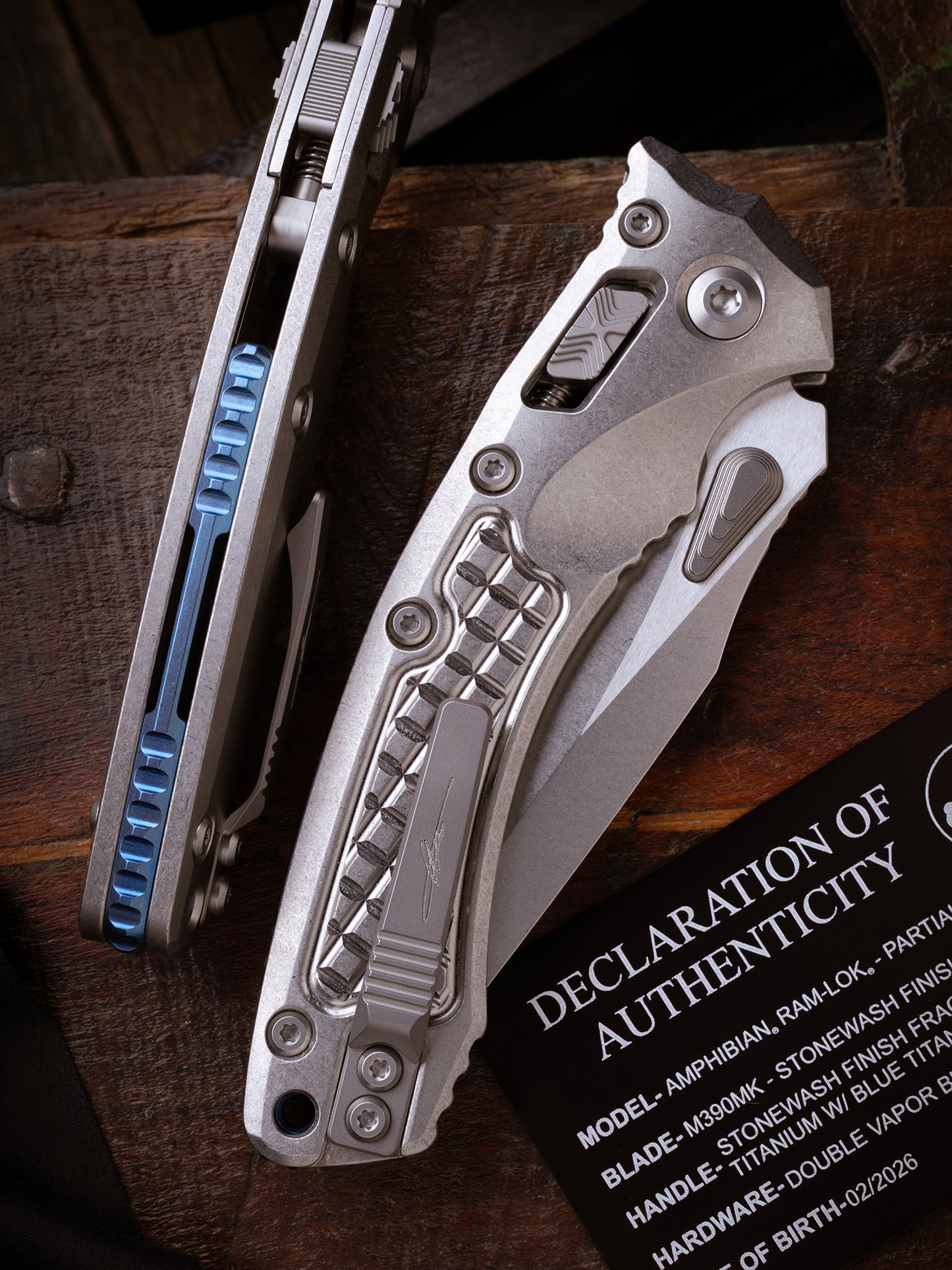 Amphibian® - RAM-LOK™ PARTIAL SERRATED MARFIONE SELECT STONEWASH FINISH STONEWASH FINISH FRAG PATTERN TITANIUM W/BLUE TITANIUM ACCENT DOUBLE VAPOR BLAST STAINLESS (137RL-11FRMS2)